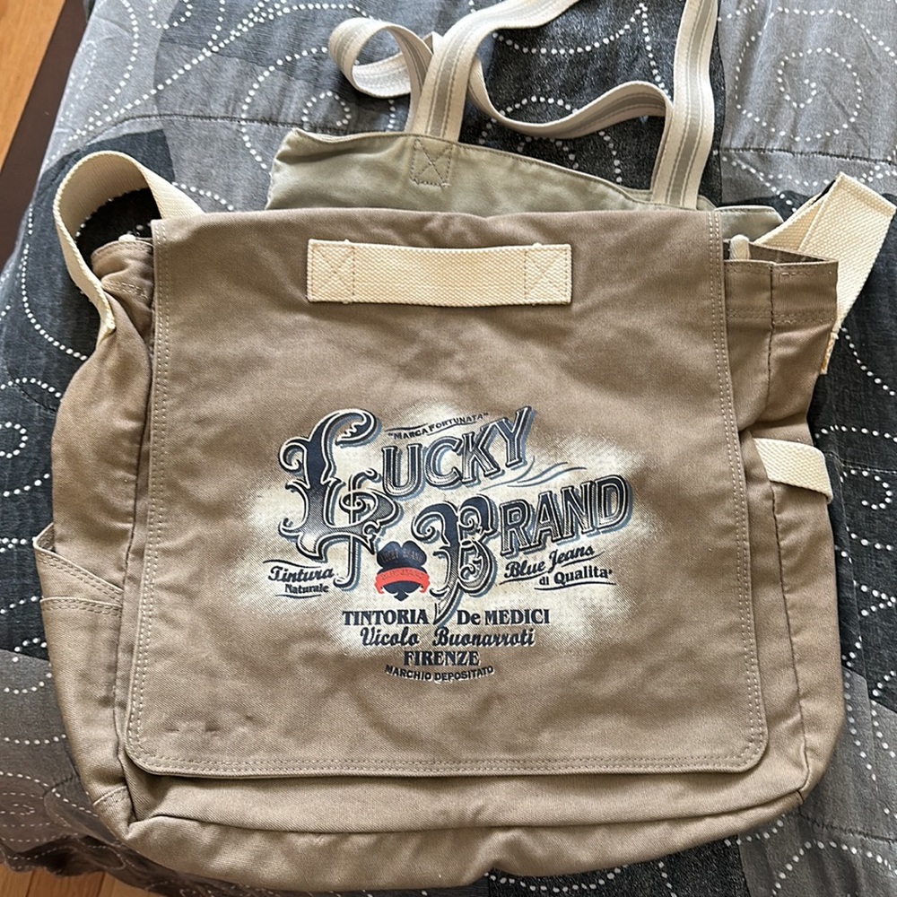 Lucky Brand large canvas olive green messenger bag w adjustable beige strap.